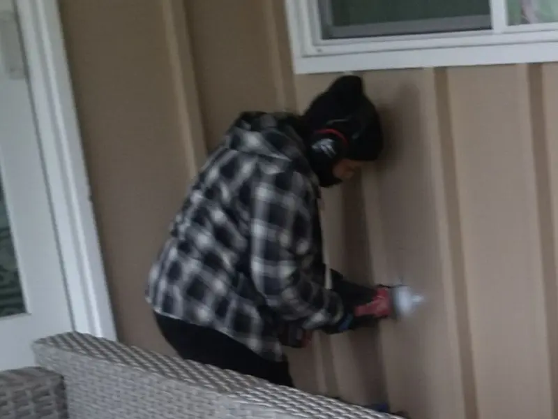 Professional electrician installing an exterior outlet in Noble